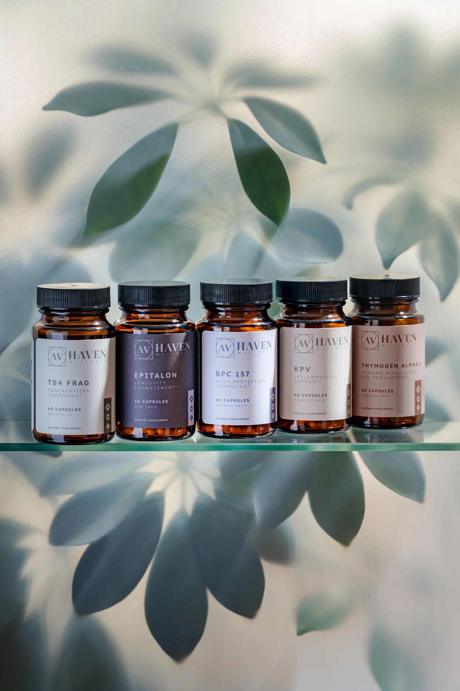 The five Haven Wellness oral peptide bottles on a glass shelf